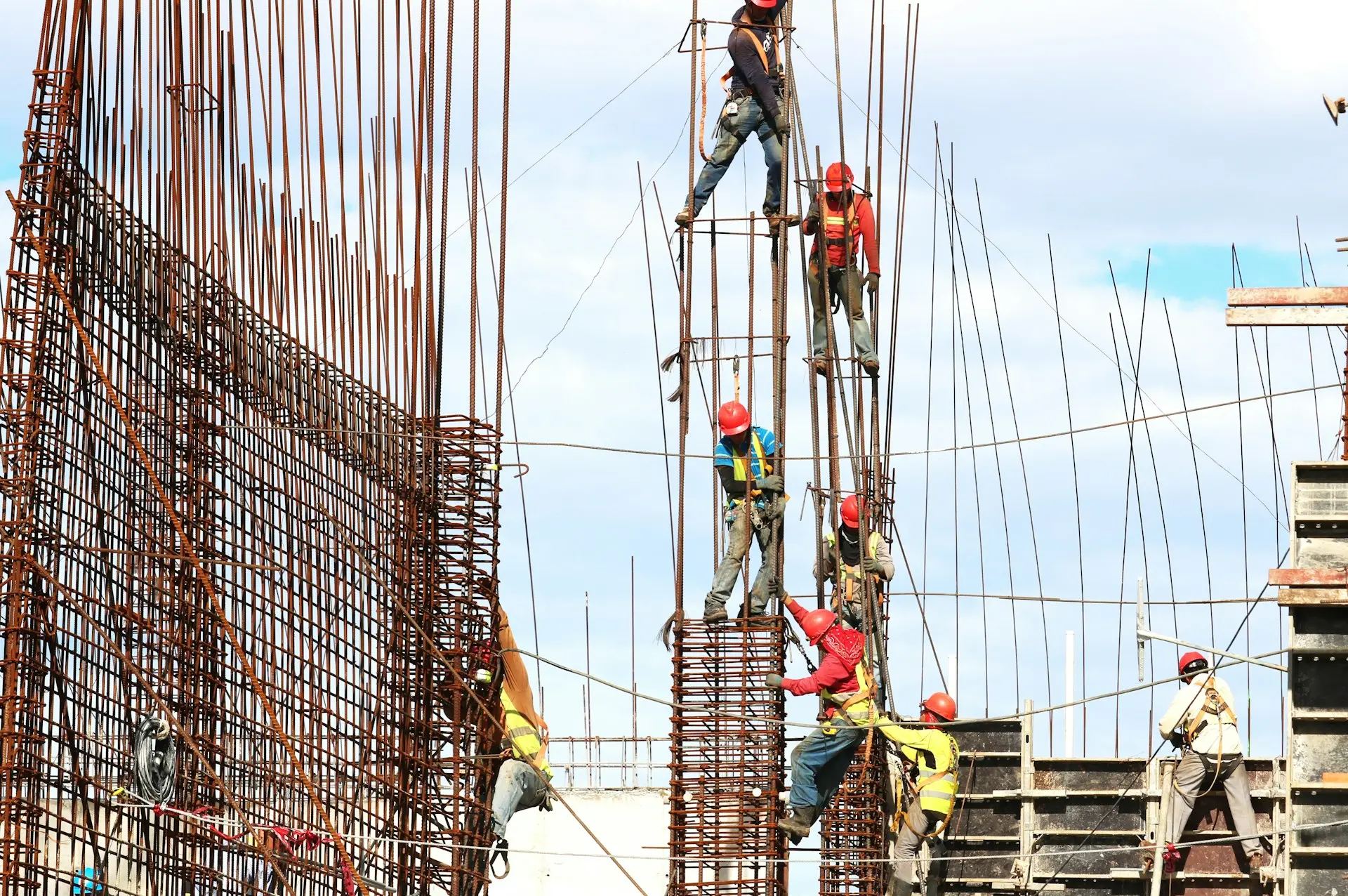 people working on building during daytime